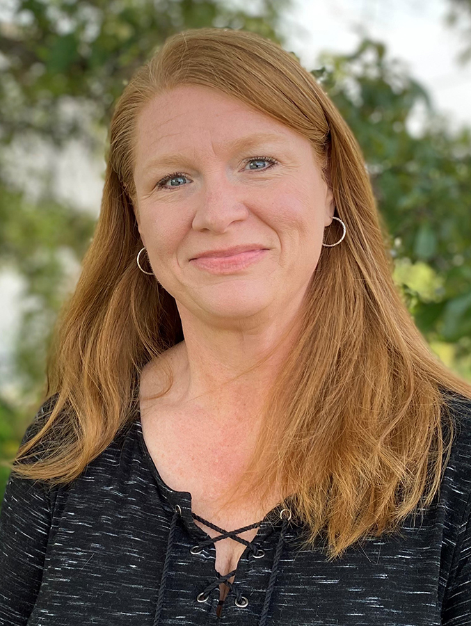 Woman with red hair wearing a black shirt