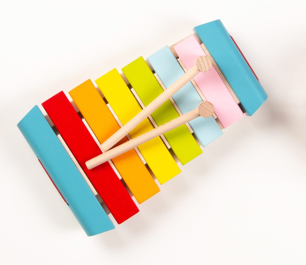 Top view of a colorful wooden xylophone on white background.
