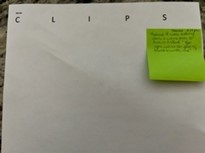 Piece of paper with C,L,I,P, and S written across the top, a post it note is under the S.